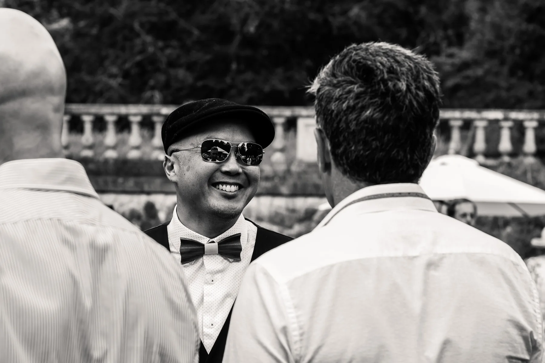 Nelson Chan in conversation with colleagues at a community gathering